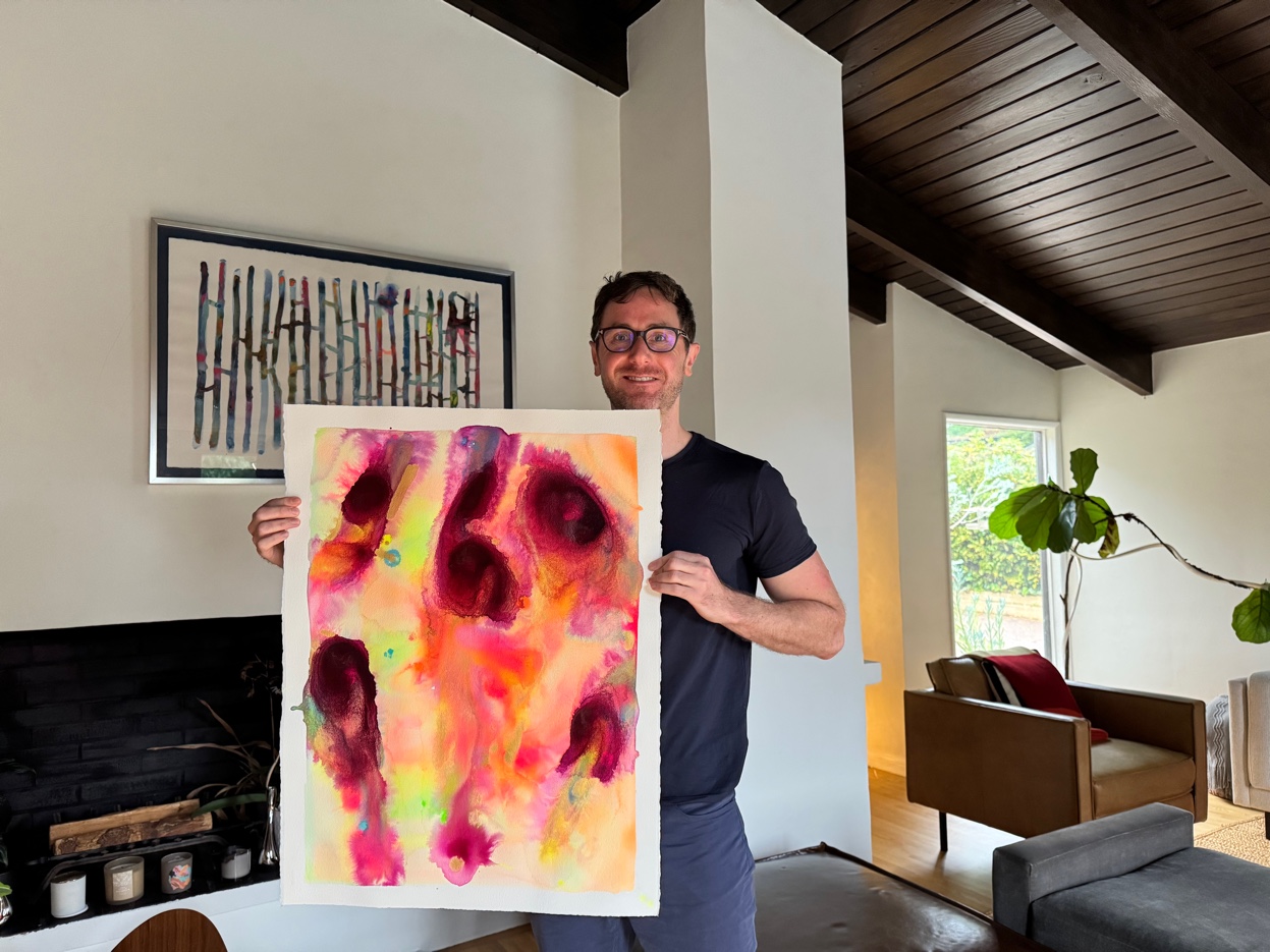 Alex Menenberg in the studio with artwork