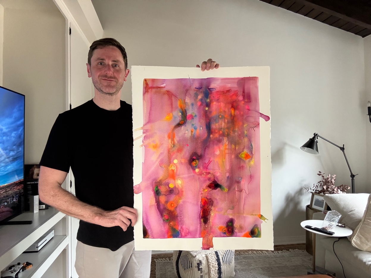 Abstract watercolor painting with vibrant pinks, oranges, and blues